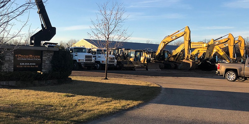crow river construction lot with trucks and vehicles