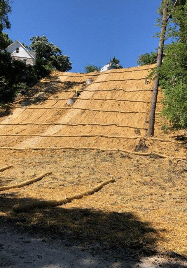 A hillside where Crow River Construction is busy with a sanitary sewer line and implementing erosion control methods.